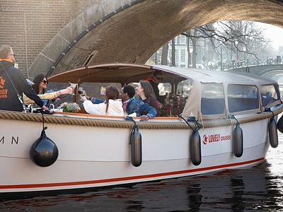 Lovely cruises people going under bridge sun