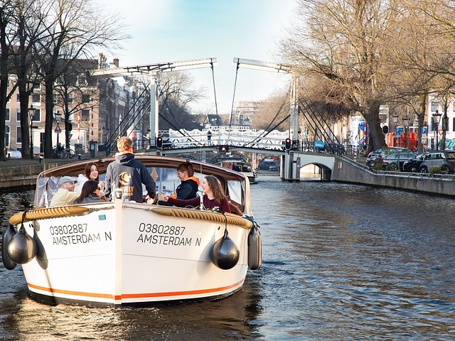 About page lovely cruises people on boat with bridge in background