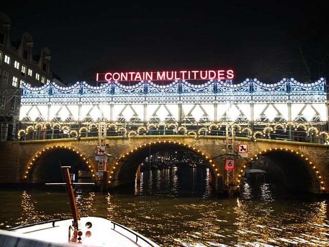 Amsterdam light festival boat with artwork on bridge
